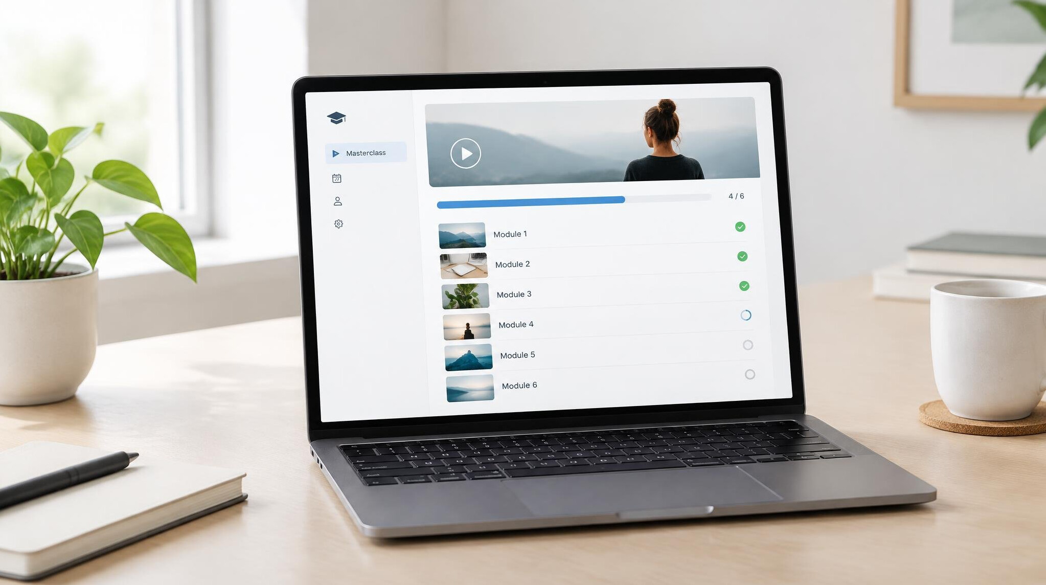 Laptop with an online masterclass dashboard showing modules and progress